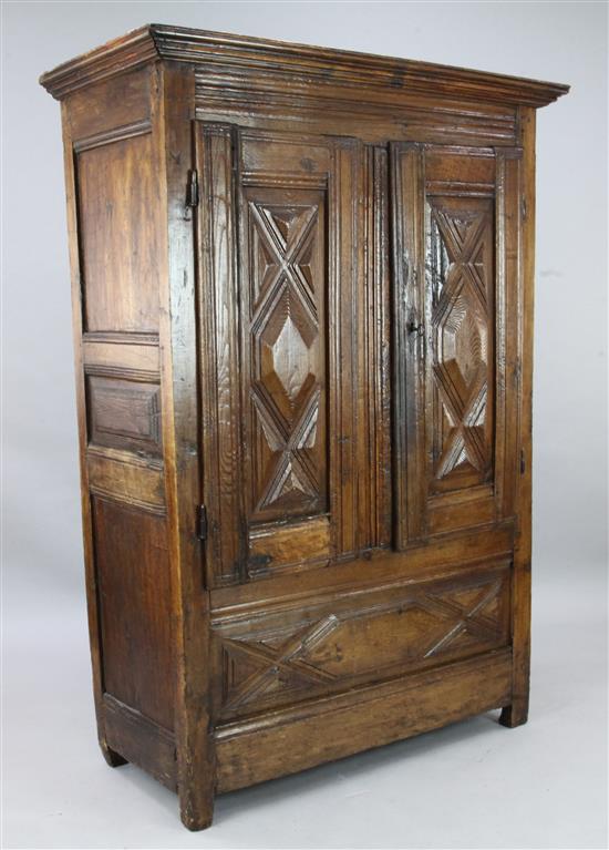 An early 18th century French provincial oak and walnut armoire, W.4ft D.1ft 10in. H.5ft 9in.